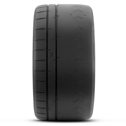 Close-up of a black car tire showing detailed tread grooves along the center and edges.