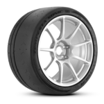 Car tire mounted on a silver alloy wheel, shown at an angle to reveal tread and rim details.