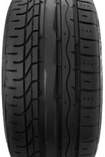 Close-up of a black tire tread showing central grooves and side ridges, highlighting tread pattern and surface texture