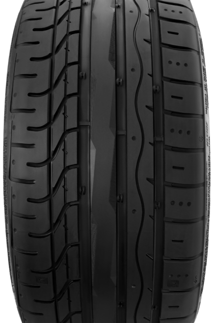 Close-up of a black tire tread showing central grooves and side ridges, highlighting tread pattern and surface texture